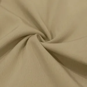 Macro-weergave van beige geweven stoftextuur voor de casual herenbroek met rechte pijp