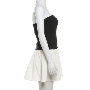Side view of chic strapless color-block patchwork pleated mini dress in black and white