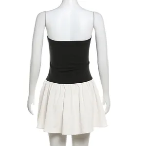 Detailed back view of a stylish black and white colorblock pleated mini dress on a mannequin