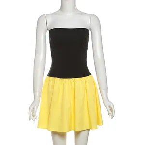 Frontal detail of a stylish color-block pleated strapless mini dress in black and yellow