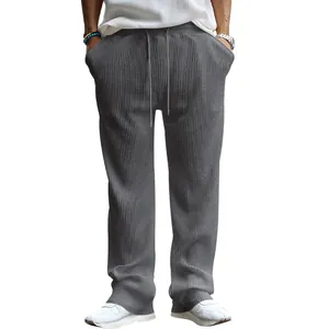 Vista detallada de la textura acanalada gris del pantalón ancho de hombre con cordón