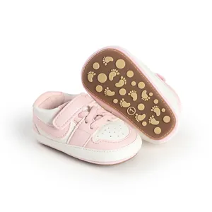 Pink and white baby walker shoes featuring a non-slip rubber sole with cute footprint patterns