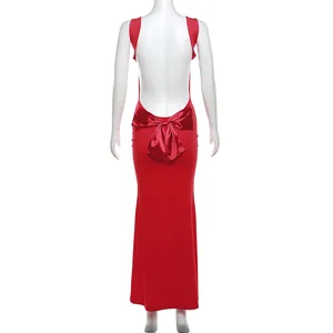 Detailed back view of an elegant red backless maxi dress featuring a large satin bow