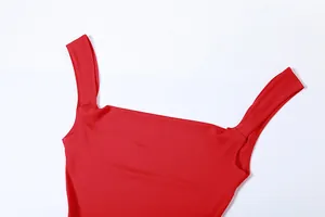Detail view of red bodycon dress featuring elegant square neckline and wide straps.