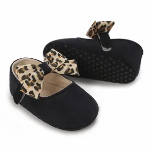Detailed view of black soft-sole baby girl walker shoes featuring a stylish leopard print bow