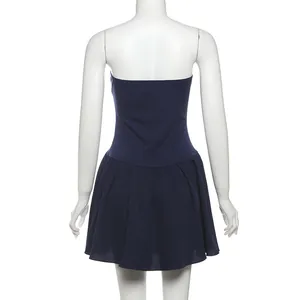 Detailed back view of a navy blue strapless mini dress with a pleated flared skirt