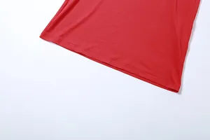 Detailed macro view of the hemline and fine stitching on a vibrant red bodycon dress