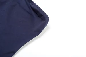 Detailed close-up showing the navy blue fabric texture and fine stitching of the slim-fit dress