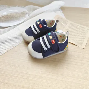 Top view of navy blue baby walking shoes with cute car embroidery and soft sole detail