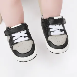 Close-up of black and grey baby walking sneakers with hook-and-loop strap