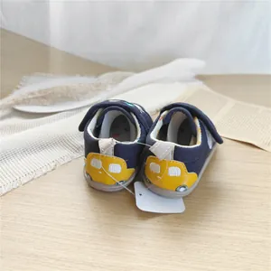 Rear view of navy baby walking shoes with yellow car embroidery on the soft sole