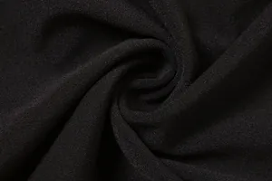High-quality close-up of soft black pleated fabric texture for slim fashion dress