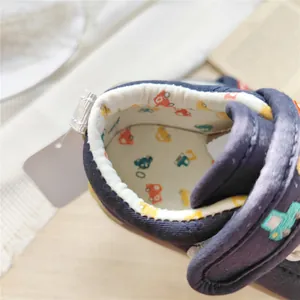 Close-up of soft inner lining with car patterns on navy baby walking shoes