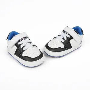 Close-up detail of black and white infant sporty walking shoes featuring blue inner lining