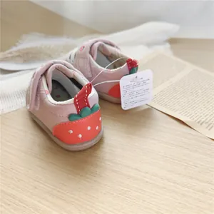 Close-up of strawberry embroidery detail on pink soft-sole baby walking shoes for infants