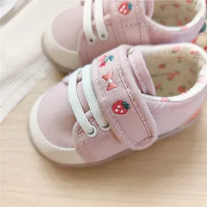 Soft sole baby walking shoes in pink canvas with cute strawberry embroidery detail.