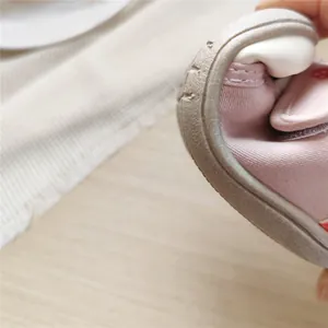 Close-up view of flexible soft sole on pink baby walking shoes for ultimate comfort