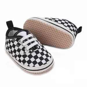 Detail view of black and white checkered baby walking shoes with non-slip soft sole