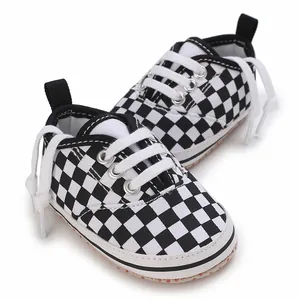 Close-up of black and white checkered baby walking shoes with soft soles for infants