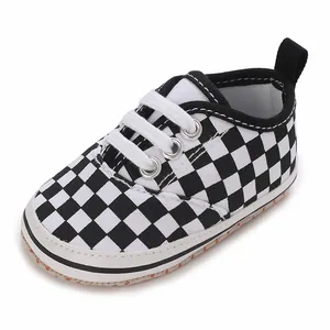 Macro detail of black and white checkerboard baby walking shoe with soft anti-slip sole