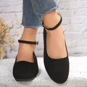 Nahaufnahme von eleganten schwarzen Wildleder-Ballerinas mit verstellbarem Knöchelriemen