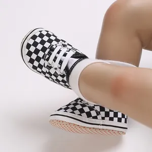 Close-up detail of black and white checkerboard baby soft sole casual walking shoes