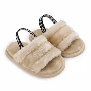 Détail de sandales douces en fourrure pour bébé beige avec bride élastique