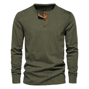 Detail view of men's olive green corduroy Henley shirt with ribbed texture and buttons