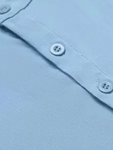 Close-up of buttons and breathable fabric on a light blue men's casual sleeveless shirt