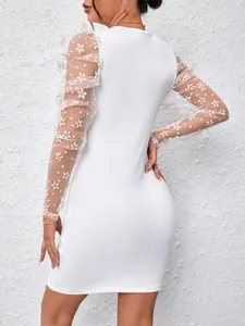 Back view detail of white mesh puff sleeve dress with floral embroidery