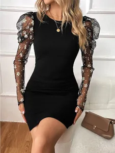 Detailed view of sheer mesh puff sleeves with floral embroidery on black bodycon dress