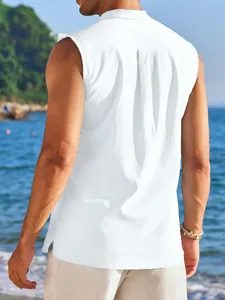Back view of a white sleeveless casual men's shirt with textured fabric on a beach