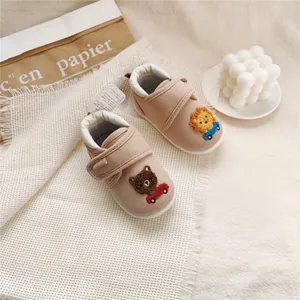Soft-sole beige baby walking shoes featuring cute bear and lion embroidery details.