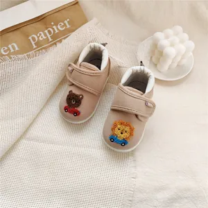 Detailed view of baby soft-sole canvas walking shoes with cute animal embroidery.
