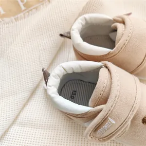 Macro view of beige baby walking shoes featuring soft padded collar and Velcro strap detail