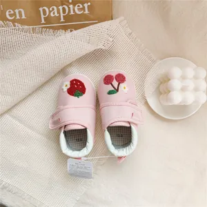 Top view of pink baby walker shoes with cute strawberry and cherry embroidery details