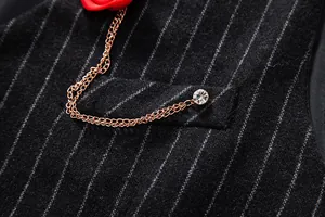 Close-up of men's vintage striped wool vest with rose gold chain and crystal detail