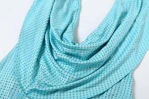 Détail d'une robe turquoise à col bénitier ornée de strass argentés scintillants