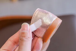Close-up of pink glitter baby princess shoe with adjustable Velcro strap detail