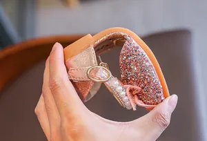 Detailed macro view of the flexible soft sole on pink rhinestone girls' princess sandals