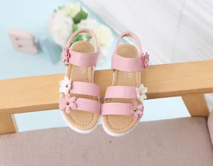 Vista detallada de sandalias rosas para niña con apliques de flores blancas y rosas
