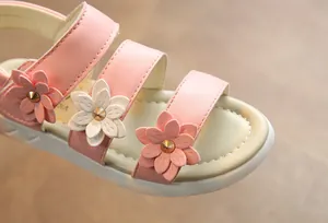 Detailed macro view of pink girls' summer sandals with beautiful 3D flower petals