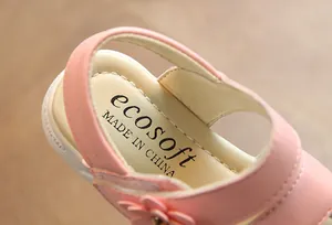 Close-up of pink girl's sandal insole featuring ecosoft brand logo and flower detail