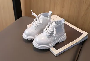 Detailed view of white sparkly children's Martin boots with side zipper design