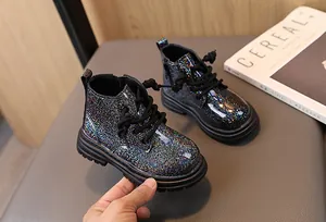 Detailed view of sparkling glitter children's Martin boots with black laces and thick soles