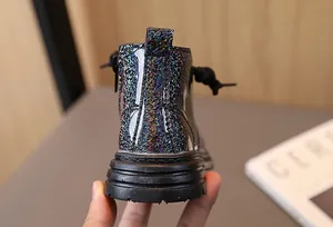 Detailed back view of children's glittery black Martin boots with a holographic finish