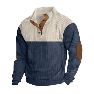 Detail view of men's color-block corduroy sweater featuring button collar and elbow patches