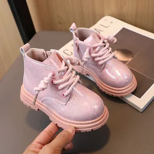 Pink glittery children's Martin boots with side zipper and chunky anti-slip sole.