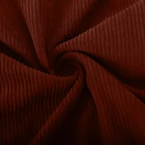Detailed close-up of premium soft dark burgundy corduroy fabric with visible vertical ribs