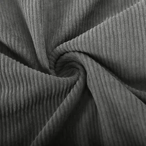 Detailed macro shot showing the soft ribbed texture of dark grey corduroy fabric material